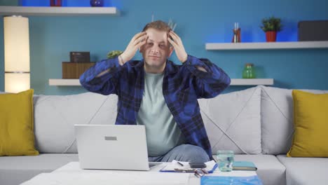 Home-office-worker-man-looks-at-camera-with-happy-and-smiling-face.