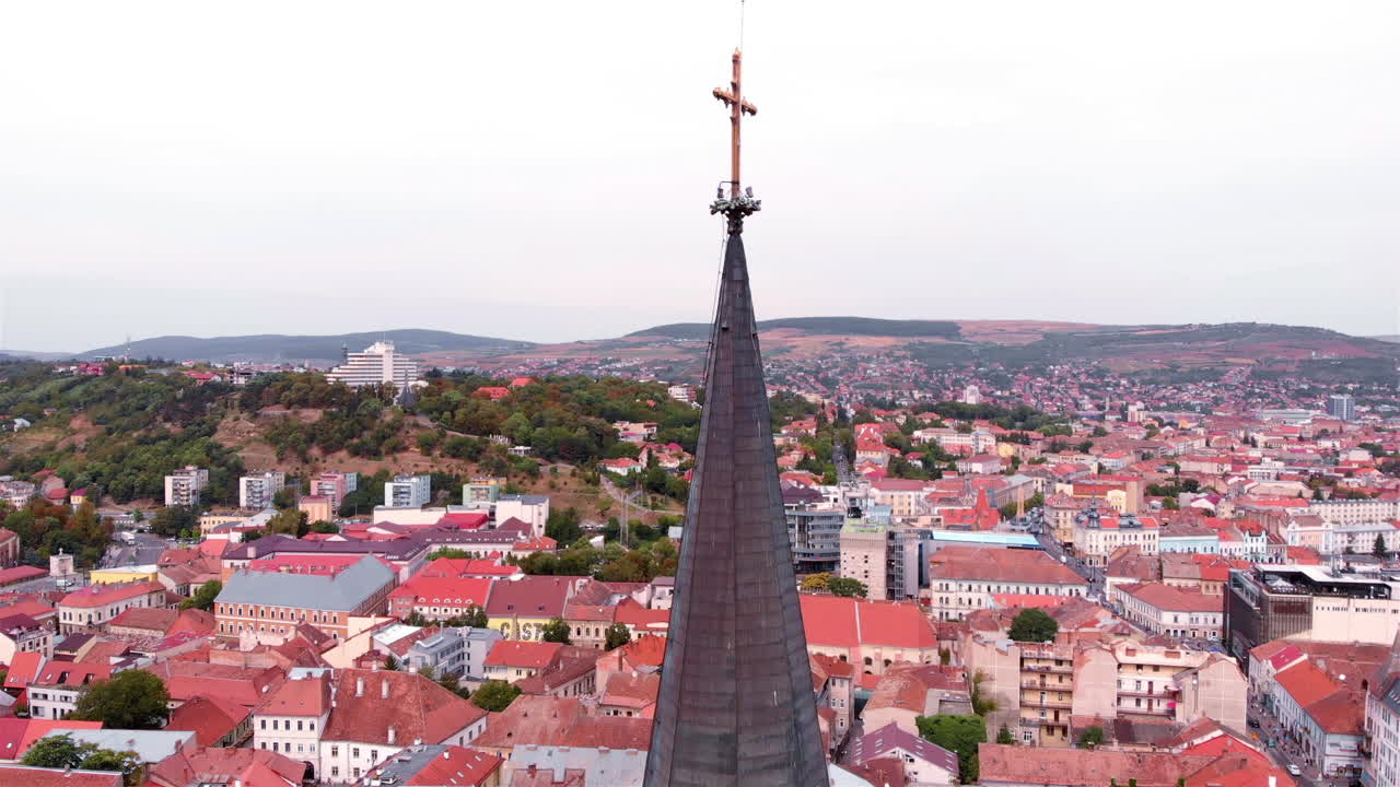 Aerial footage over Large Cross on top of church medieval tower in Europe