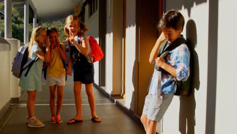 schoolkids bullying a sad boy in the corridor of elementary school 4k