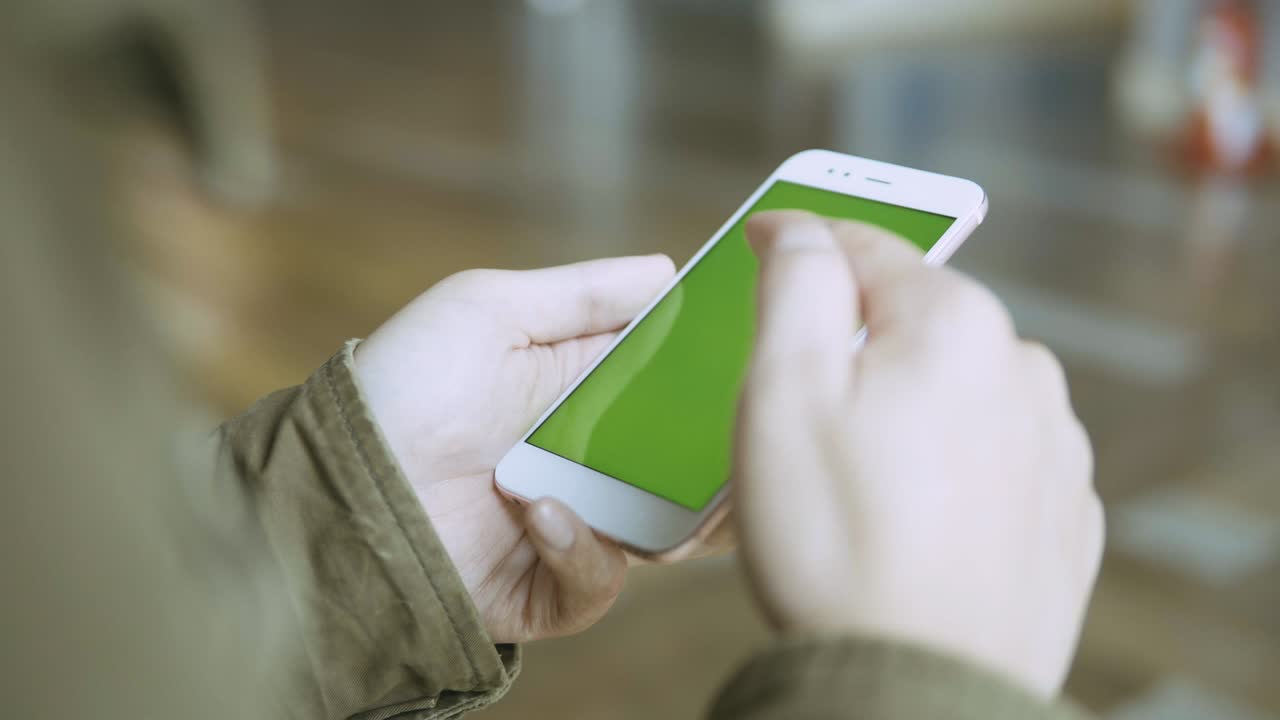 hombre toma teléfono celular con pantalla verde