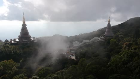 footage of drone flying over the temple doi inthanon in chiang mai in thailand with some clouds passing by