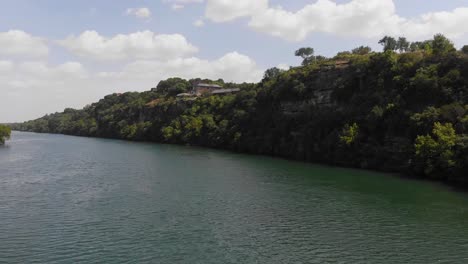 drone shot of the cliffs on ladybird lake, shot rotates to reveal the homes situated on the cliffside