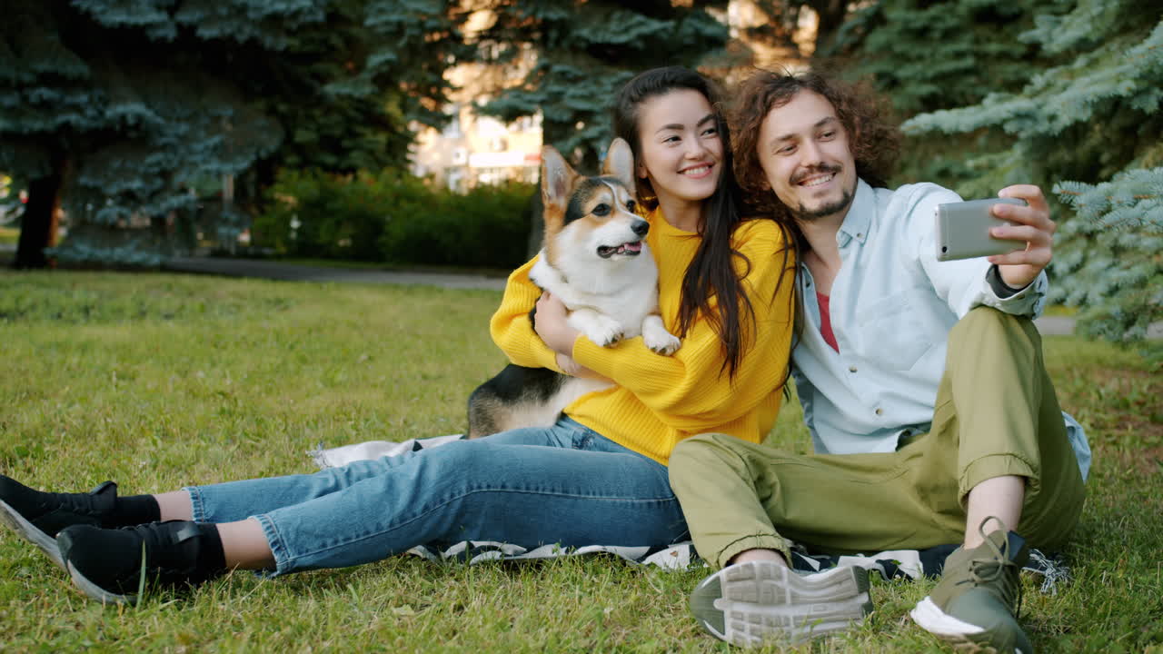 Couple Taking Selfie with Dog in Park