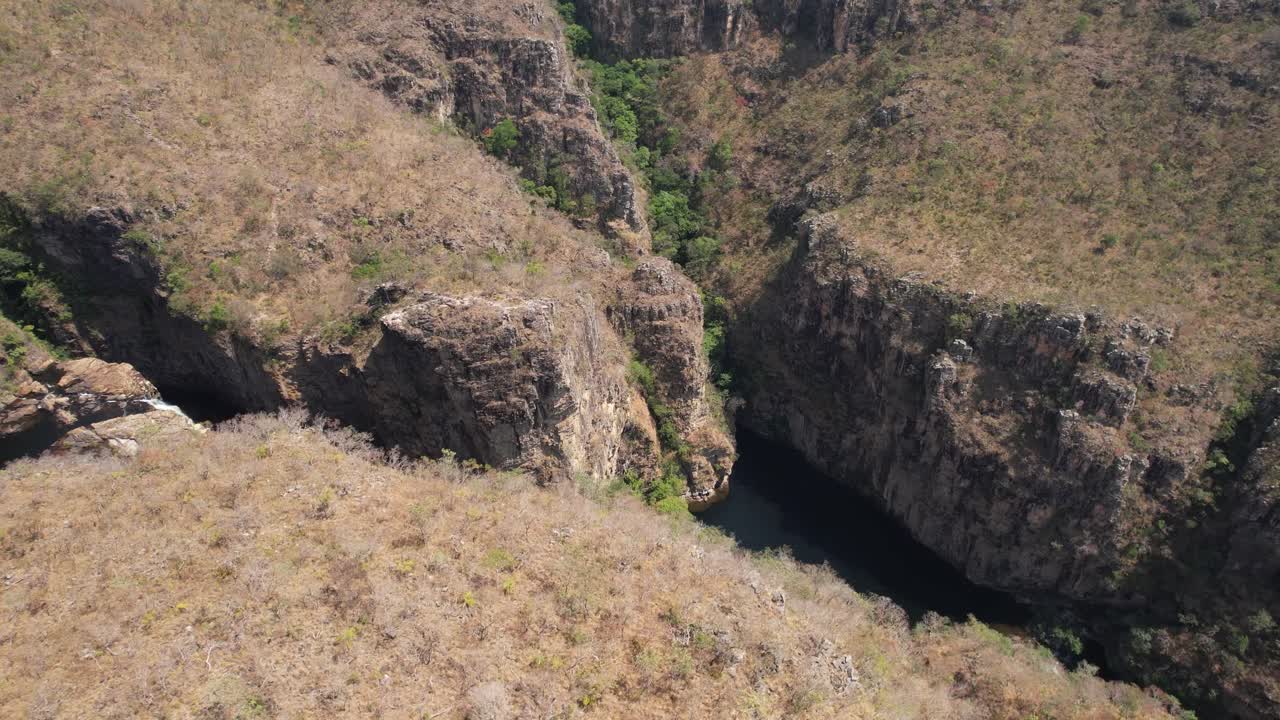drone video , valley Cataratas dos Couros, beautiful waterfall with large rocks and trees, Chapada dos Veadeiros, Goiás, Brazil