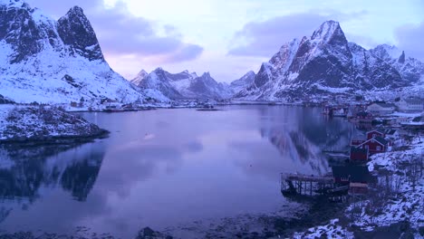 snow covers a spectacular view of a harbor and bay in a village in the arctic lofoten islands norway