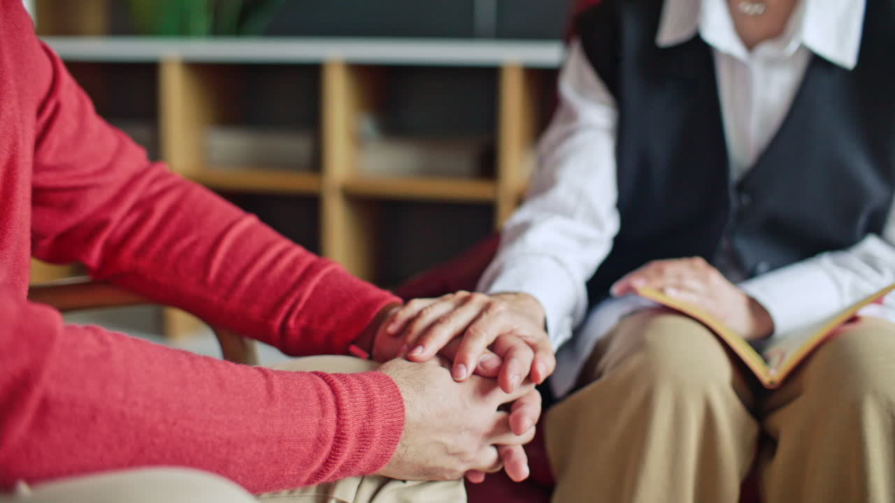 Close Up of Psychologist Holding Hands of Patient during Therapy Session