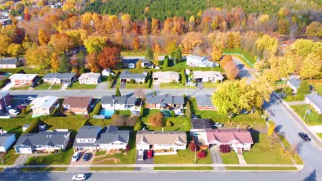 suburban neighborhood in autumn with vibrant colorful foliage, region of estrie, québec, canada.