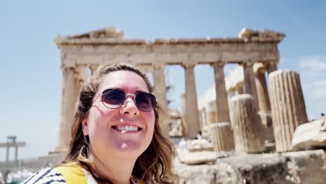 smiling woman's selfie at the parthenon ruins, athens, greece