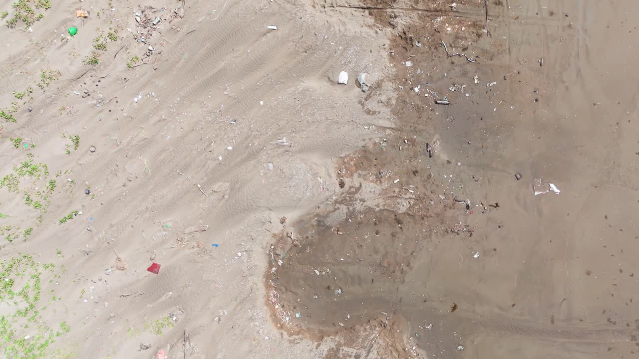 Aerial View Tilt of the Trash and Snails on the Beach in Ben Tre.