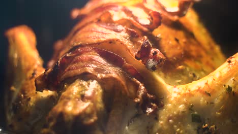 delicious looking turkey covered in bacon roasting in oven during thanksgiving