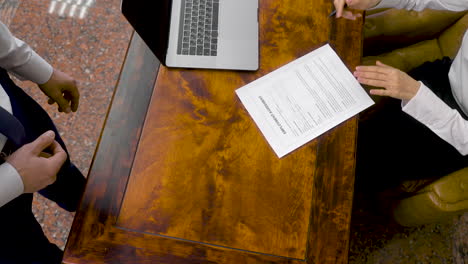 Top-View-Of-Unrecognizable-Employee-And-Boss-Signing-The-Employment-Agreement-At-The-Office