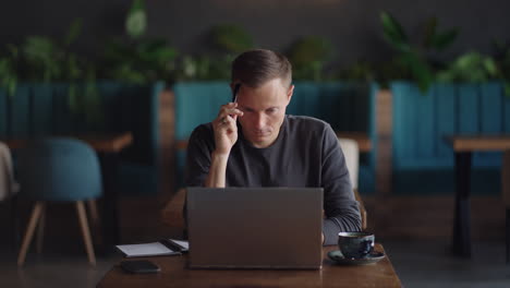 thoughtful serious young man student writer sit at home office desk with laptop thinking of inspiration search problem solution ideas lost in thoughts concept dreaming looking away