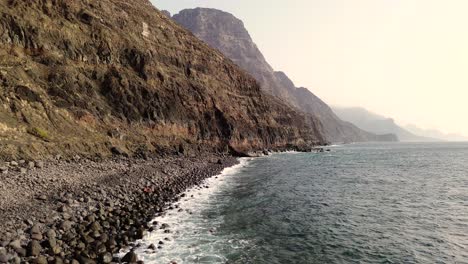 Idyllic-scene-of-two-people-at-unspoiled-virgin-beach-in-Gran-Canaria,-Spain-during-summer-time-on-vacations