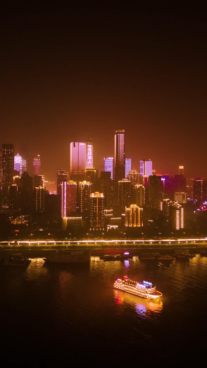 Vertical aerial view of Chongqing at night, with the illuminated ...