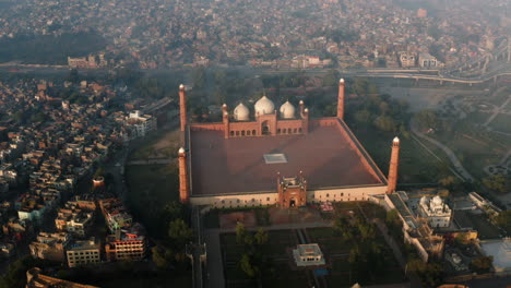 unesco world heritage - badshahi mosque with city view background during sunrise in lahore, province of punjab in pakistan