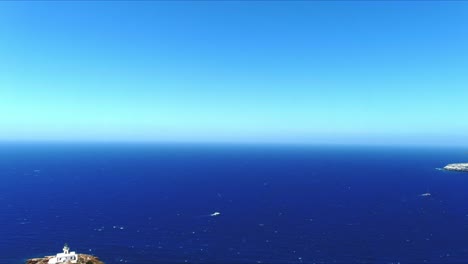 aerial 4k blue sea and sky top view over akrotiri lighthouse near boats in santorini greece