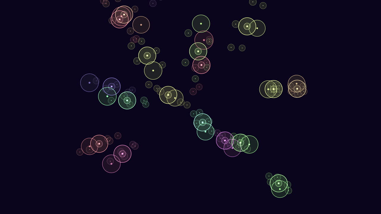 Colorful glowing bokeh circles floating on dark background abstract footage