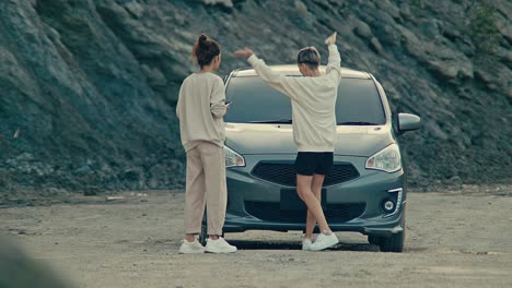 two women deal with a car breakdown and take selfies during a road trip