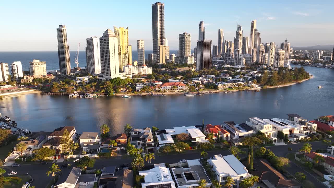 Drone flying over residential area to the city downtown, urban scenery of Gold Coast, Australia.