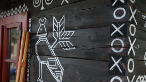 ornamental traditional slovakian symbols are painted on a wooden rural village house in čičmany, slovakia, worlds cultural heritage, a famous landmark in central europe