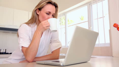 Mujer-Feliz-Usando-La-Computadora-Portátil-Y-Tomando-Café