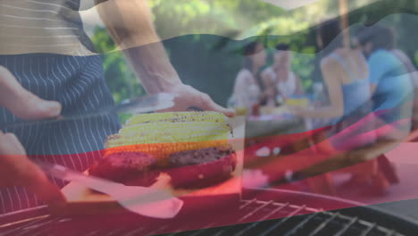 grilling corn and meat with friends gathered, flag animation overlay in background