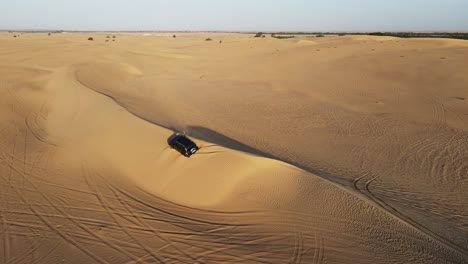 4K:-Drone-view-of-a-4x4-stuck-in-the-sand-during-the-desert-safari-in-the-Al-Qudra-desert-of-Dubai,-United-Arab-Emirates