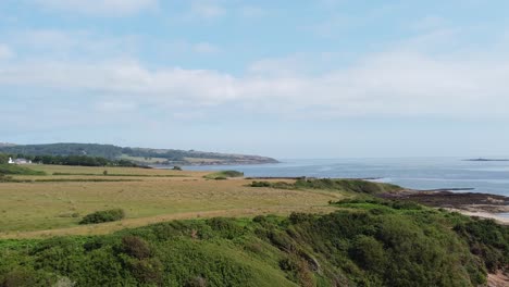 traeth lligwy anglesey eroded coastal shoreline establishing aerial view over scenic green rolling welsh weathered coastline