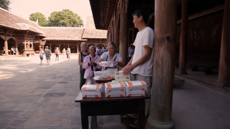people lining up for food boxes
