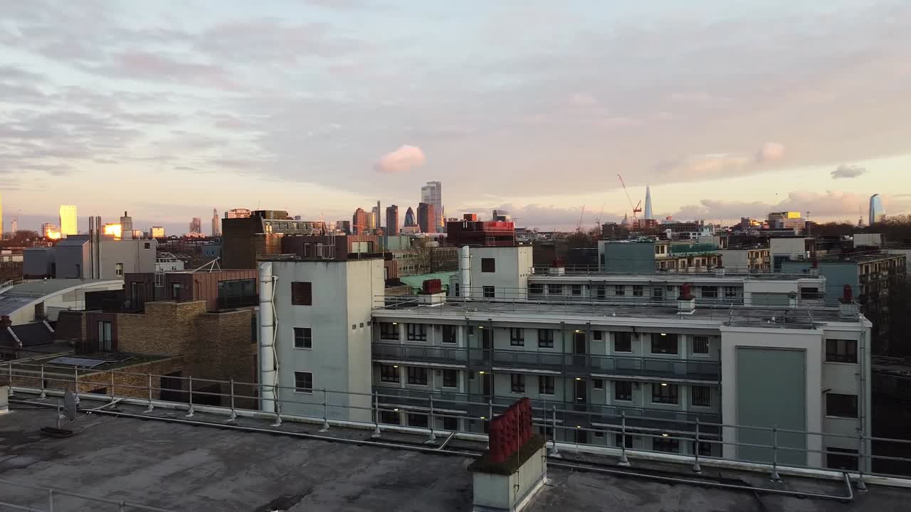Sunset over rooftops of Holloway, North London. Drone wide shot of cityscape.