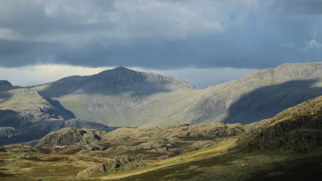 rugged and mountainous landscape with cloud shadows moving across