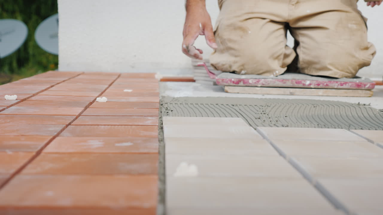 Master Lays The Tiles On The Floor Puts It On Glue Close-Up