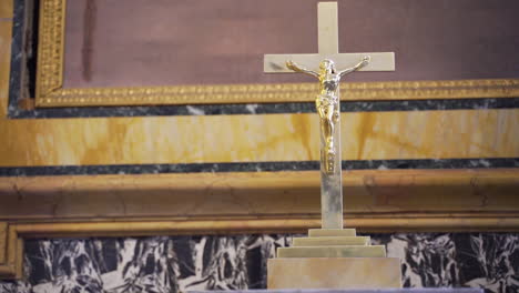 golden statue of jesus christ on the cross in a classic church