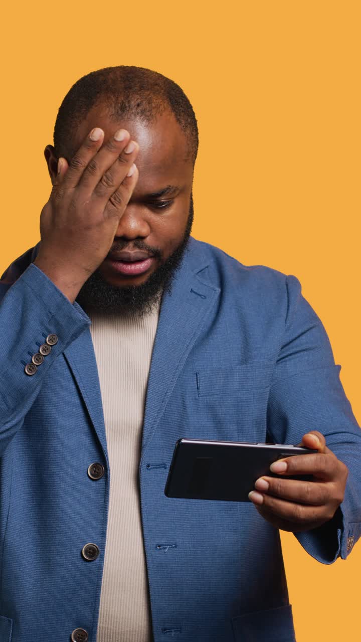 African American Man Playing Mobile Game and Getting Frustrated