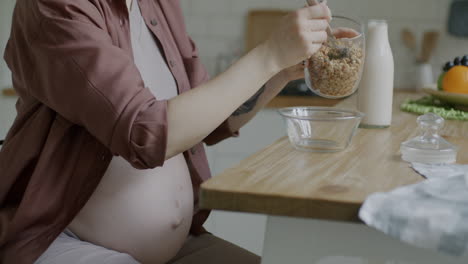 pregnant woman eating granola breakfast