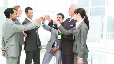 business team celebrating a success in business with champagne