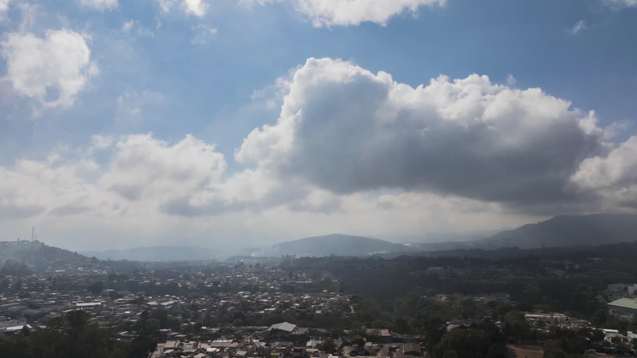 A hyperlapse of a bright clouds over urbanized mountains of Guatemala