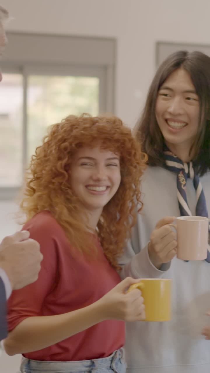 Happy coworking colleagues talking and laughing in the office