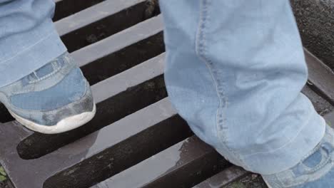 feet walking across urban drain