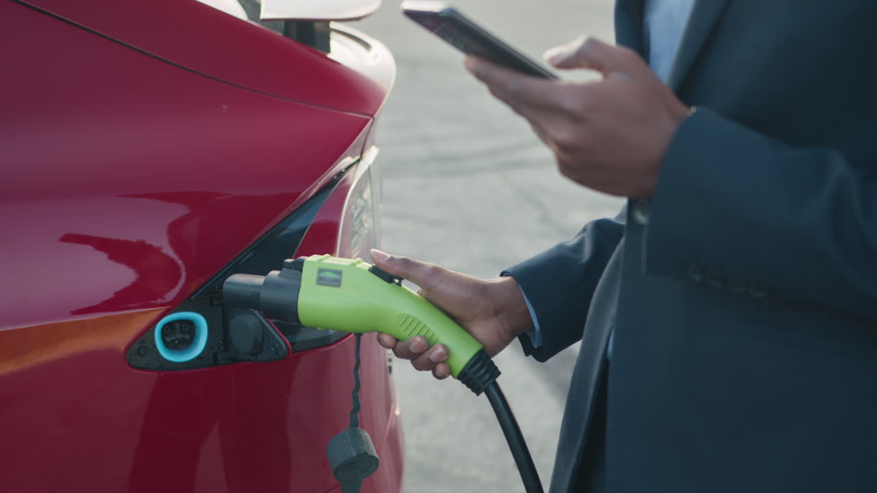 전기 자동차 를 충전 하는 사업가