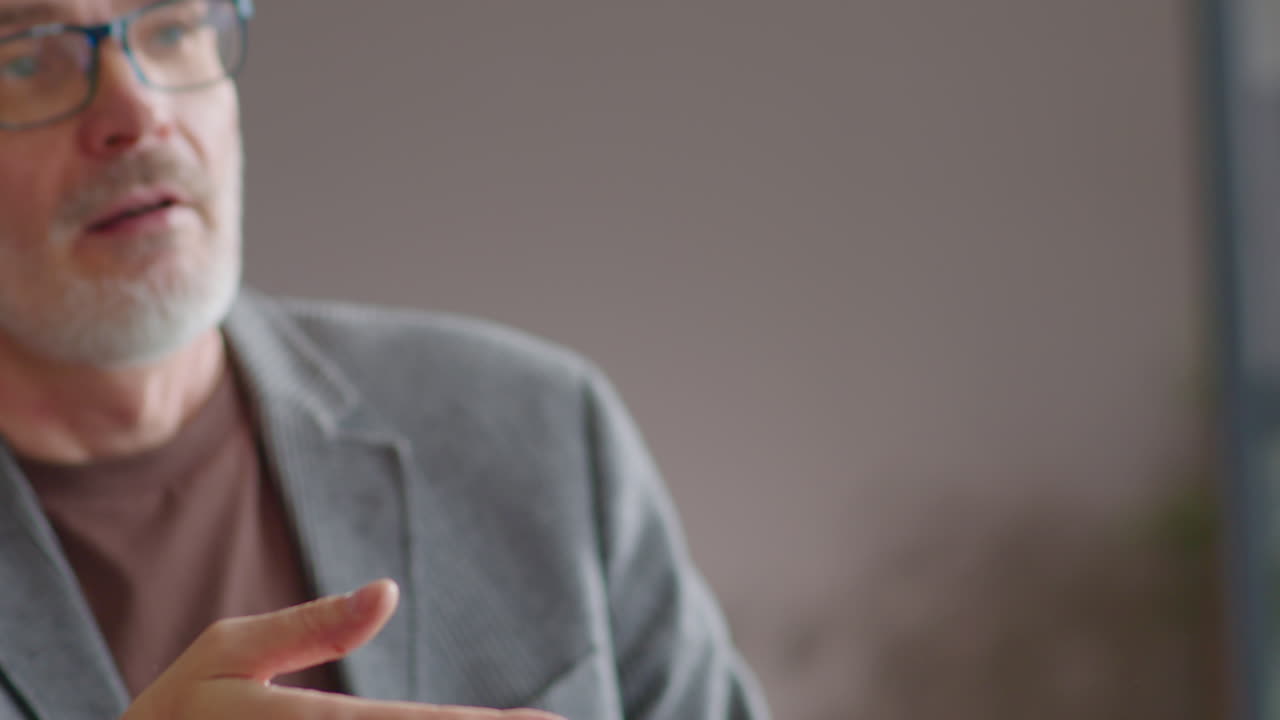 Senior Businessman Shaking Hands and Talking with Colleague