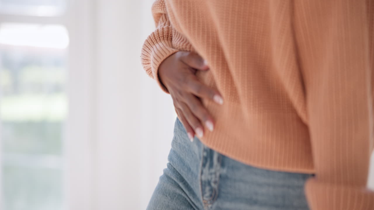 Stomach, cramps and hands of a woman with ache