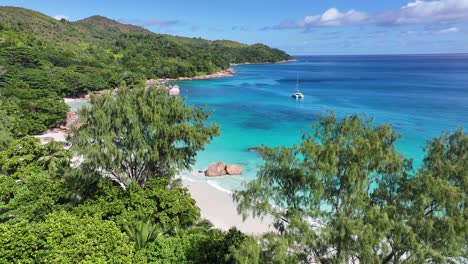 stunning tropical beach with turquoise ocean and lush green hills