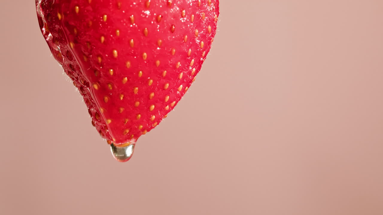 Close-up of a single, wet strawberry with water droplets