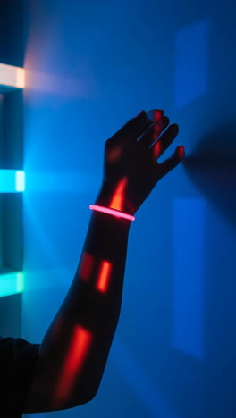 A Hand with a Glowing Bracelet in Neon Lights