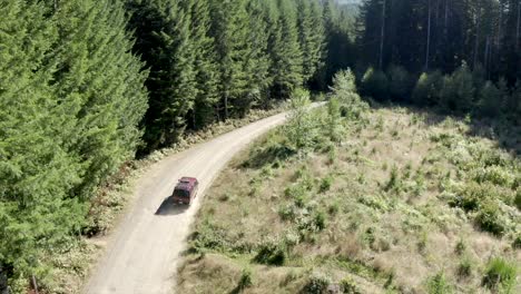 VW-Van-vintage-van-driving-through-forest-aerial-view-4k-drone