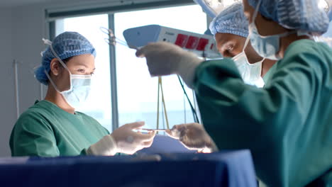 Diverse-female-and-male-surgeons-in-masks-passing-surgical-tools-during-operation,-slow-motion