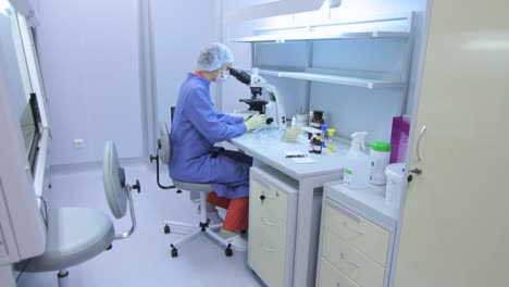 lab technician using laboratory microscope. researcher doing experiment