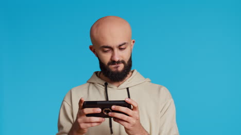 middle eastern person playing mobile video games on app