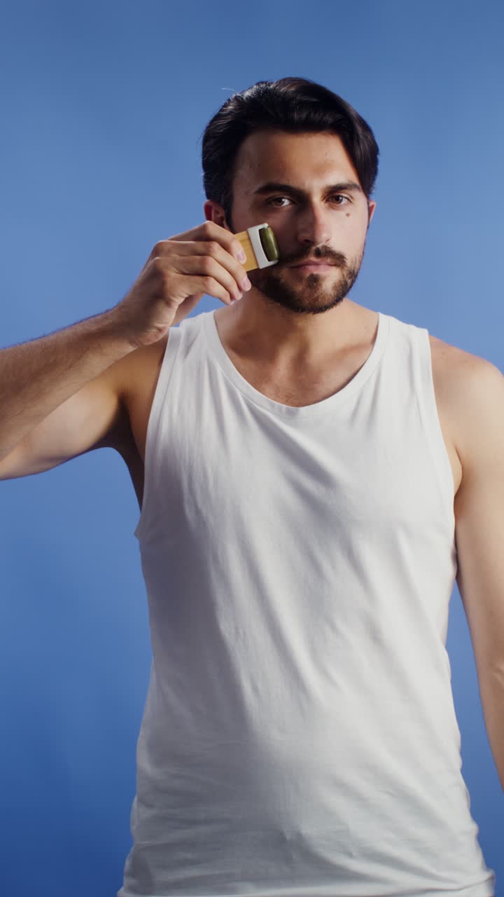 Man using face roller for grooming